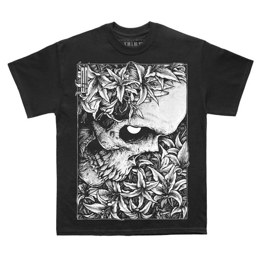 Black t-shirt with oversized rectangular print of skull in profile amongst flowers and foliage. A striking illustration by artist Godmachine.